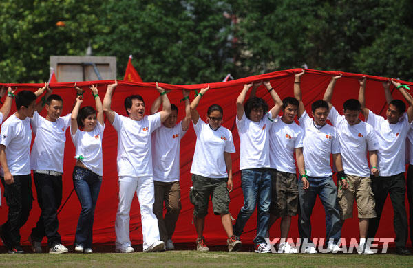  5月11日，成龙等和北川师生共擎巨幅国旗。